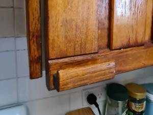  Most of the 1950s kitchen cupboard doors don't close properly. They're also really sticky from the varnish that is on it. 