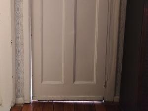 Door doesn't match up with door frame and lets light/air through
