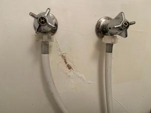 Paint and water damage around inside taps