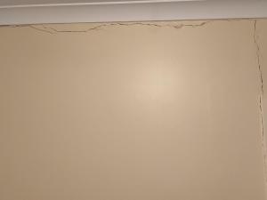 Cracks on wall in community housing property (SA)