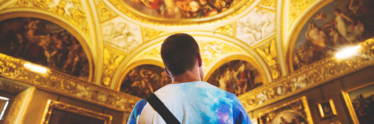 Person in an art gallery observing the artwork