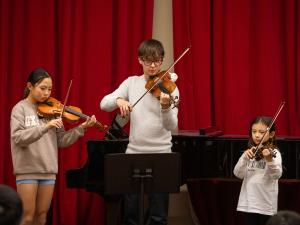 L–R: Ava Arbon (violin), Kai Gerby (violin) and Alyssa Zhang (violin) performing at our OMA Mid-Year Concerts 2025