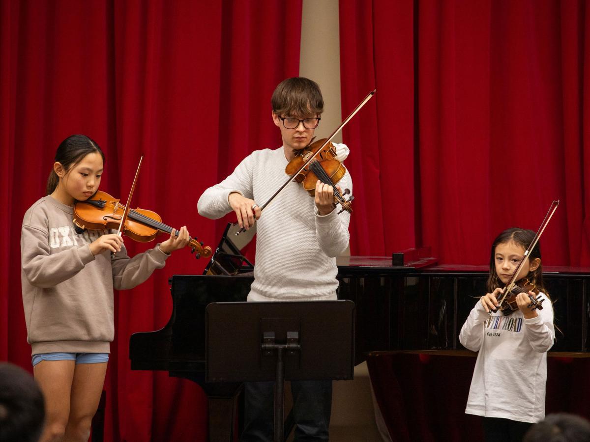 L–R: Ava Arbon (violin), Kai Gerby (violin) and Alyssa Zhang (violin) performing at our OMA Mid-Year Concerts 2025