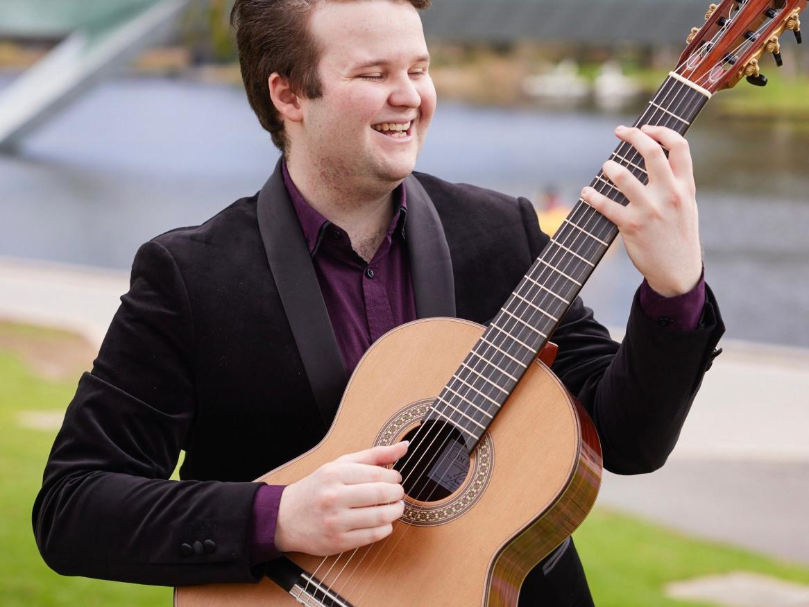 Third year student Connor Whyte poses with classical guitar