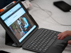 student working on apple technology
