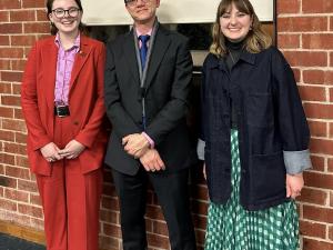 Roisin Murphy-Haines, Lucy Vari, and Andrew van der Vlies stand together and smile.
