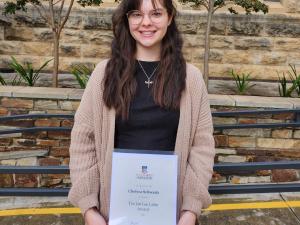 Chelsea Schwartz holds the Jan Lee Latin award.