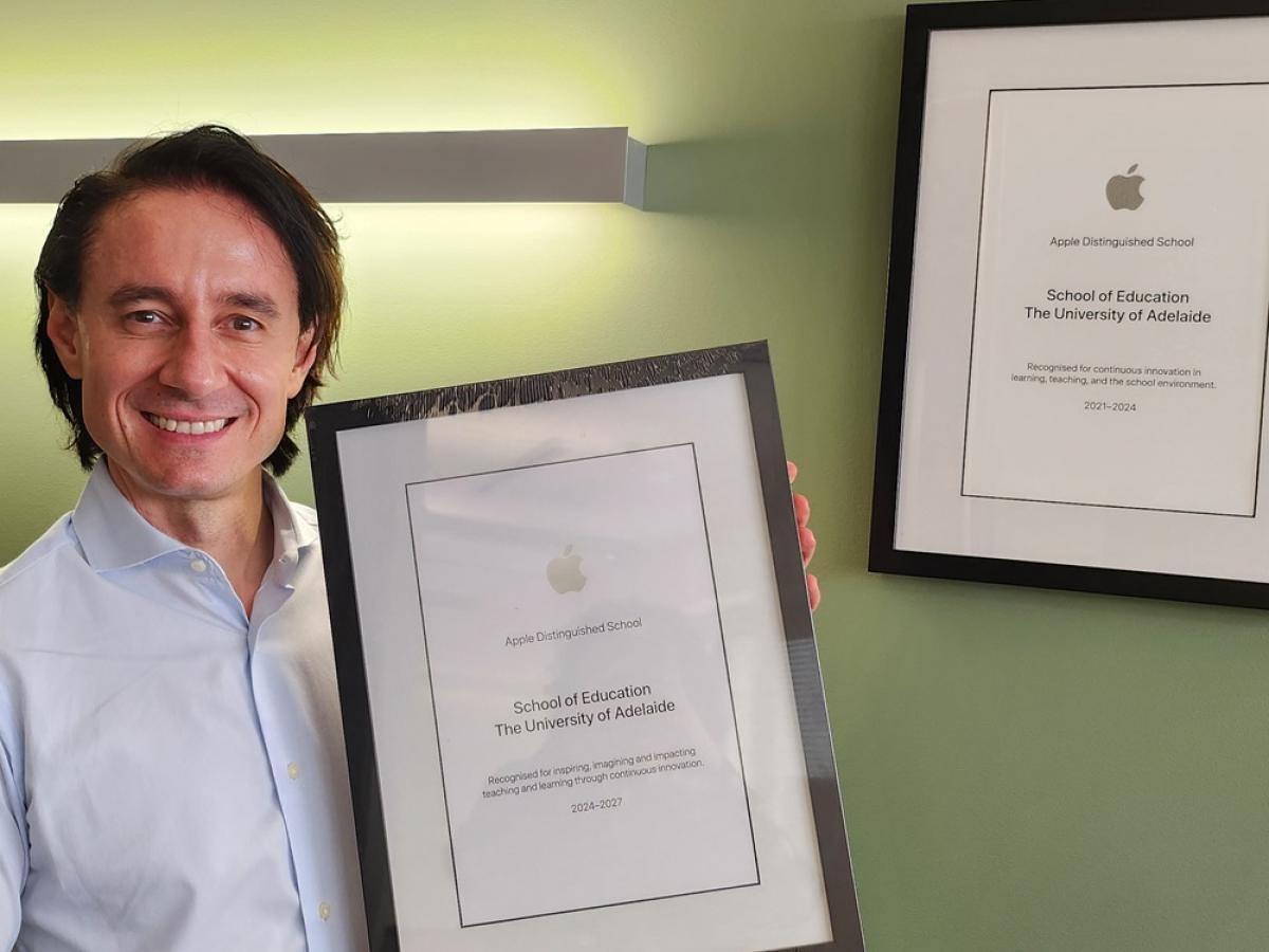 Walter Barbieri holds the Apple accreditation plaque and smiles