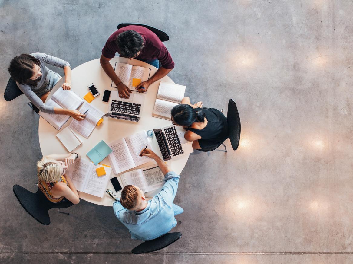 students-sitting-around-desk