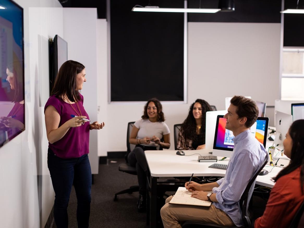 A group of staff smile during a presentation.