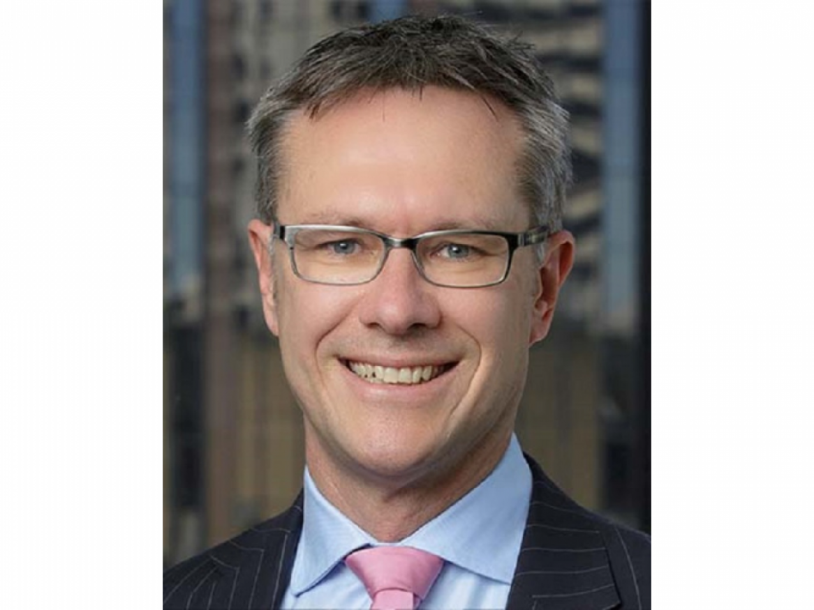 Guy Debelle smiles into the camera
