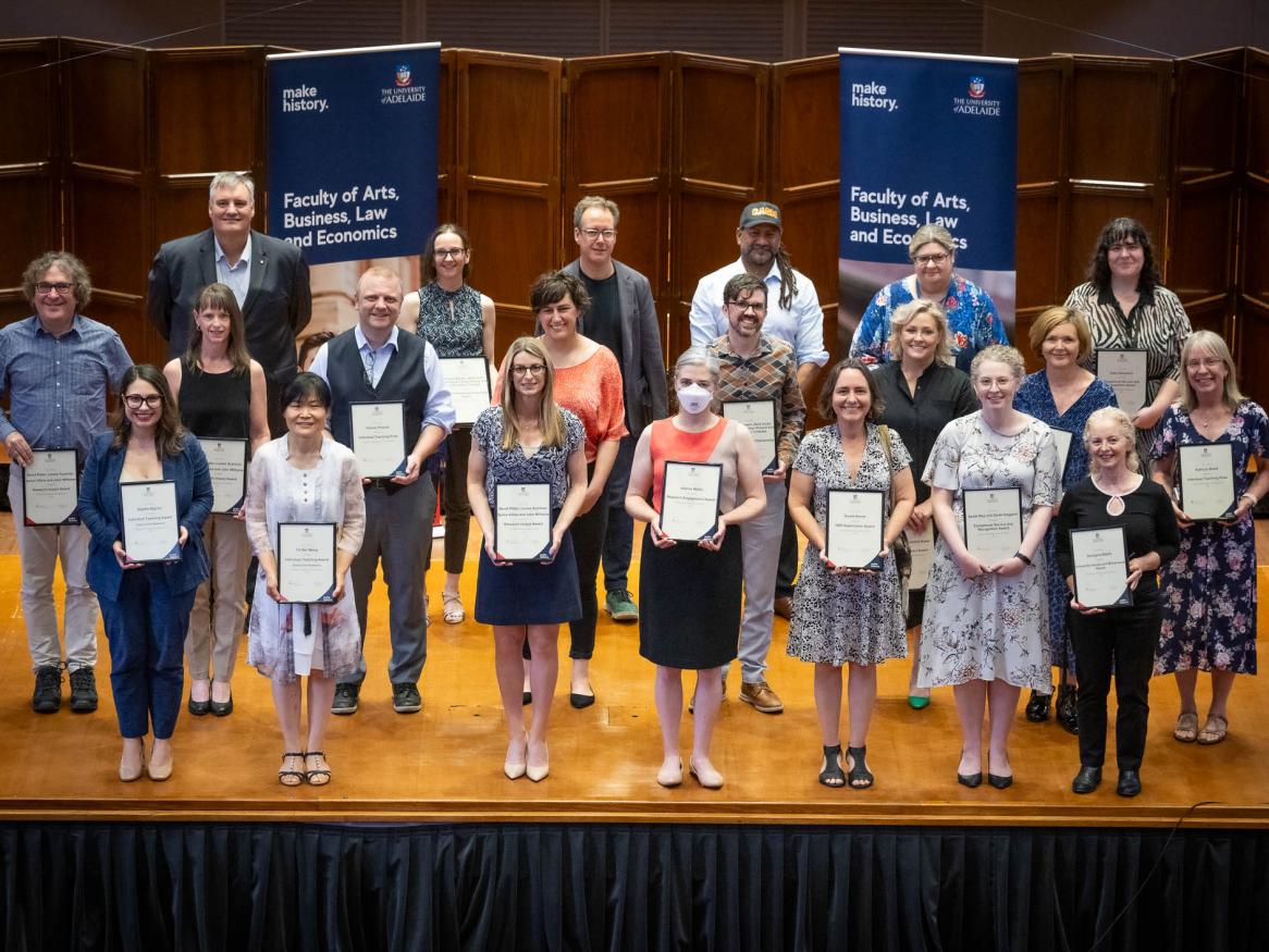 Faculty of ABLE Awards for Outstanding Achievement recipients stand on stage in Elder Hall