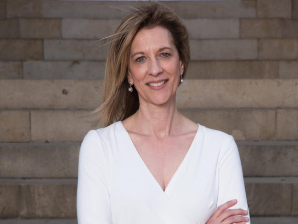 Stephanie smiles in front of steps