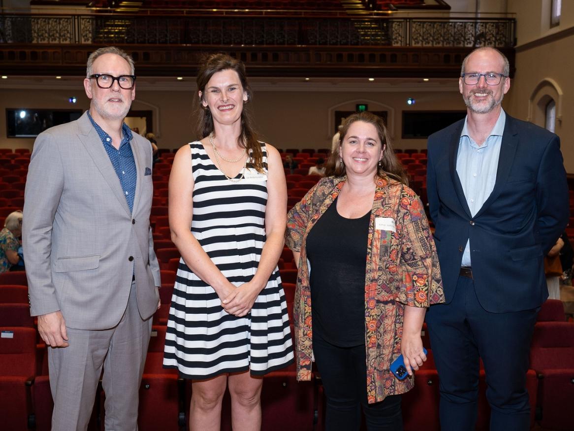 David, Ania, Sally, and Peter stand together and smile
