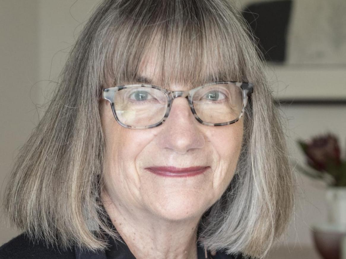 Margot Osborne wears glasses and smiles