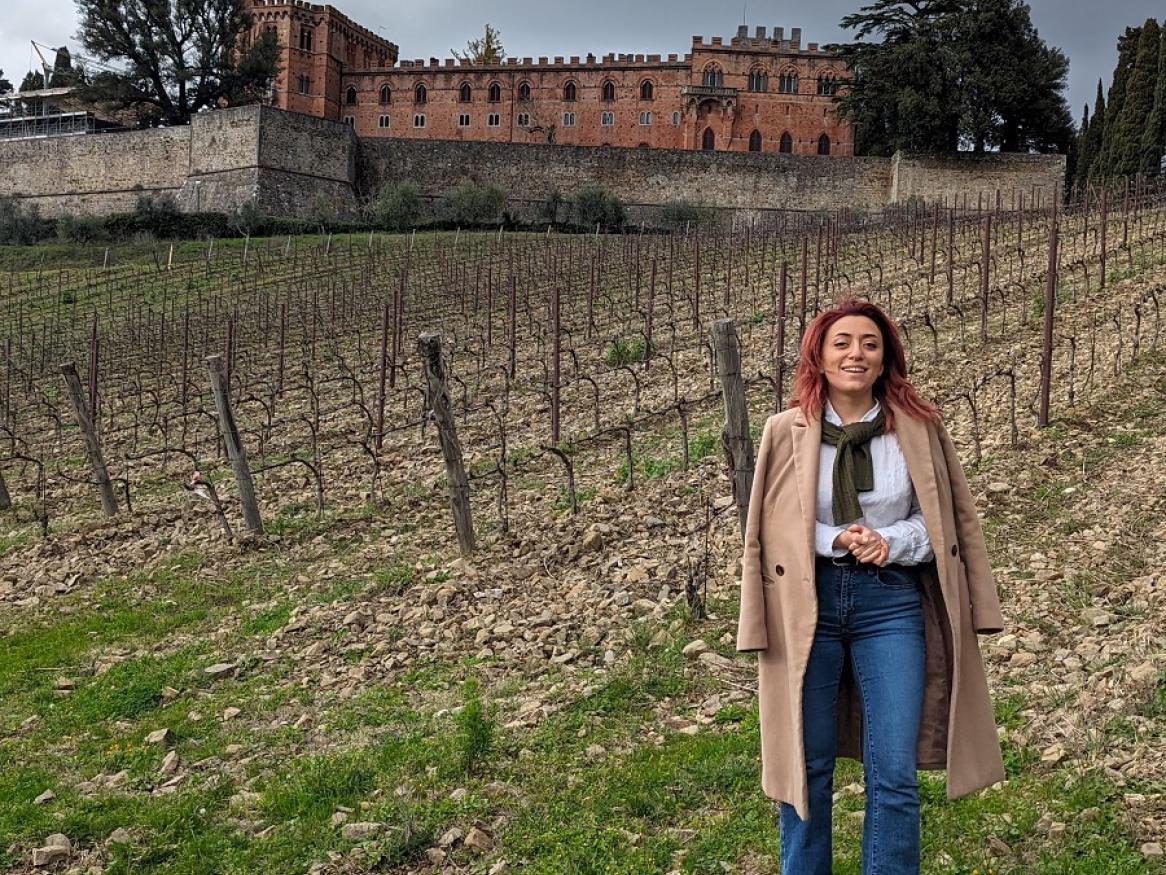 Syuzanna Mosikyan at a Chianti vineyard, with grey clouds above.