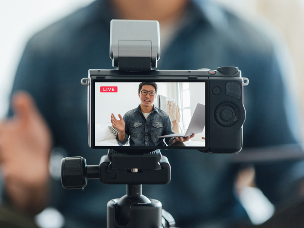 A person films themselves with a camera